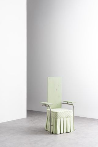 green chair in bare room