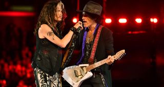 Aerosmith's Steven Tyler and Joe Perry share the mic as they perform live, with Perry playing an oddball triangular-shaped electric