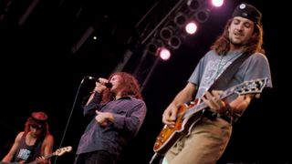 Photo of Jeff AMENT and PEARL JAM and Eddie VEDDER and Stone GOSSARD, L-R: Jeff Ament, Eddie Vedder, Stone Gossard - performing live onstage