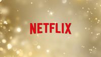 Netflix logo on a gold sparks background