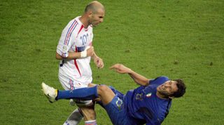 Marco Materazzi of Italy falls after being headbutted by Zinedine Zidane of France during the 2006 FIFA World Cup final between Italy and France at the Olympiastadion in Berlin, Germany