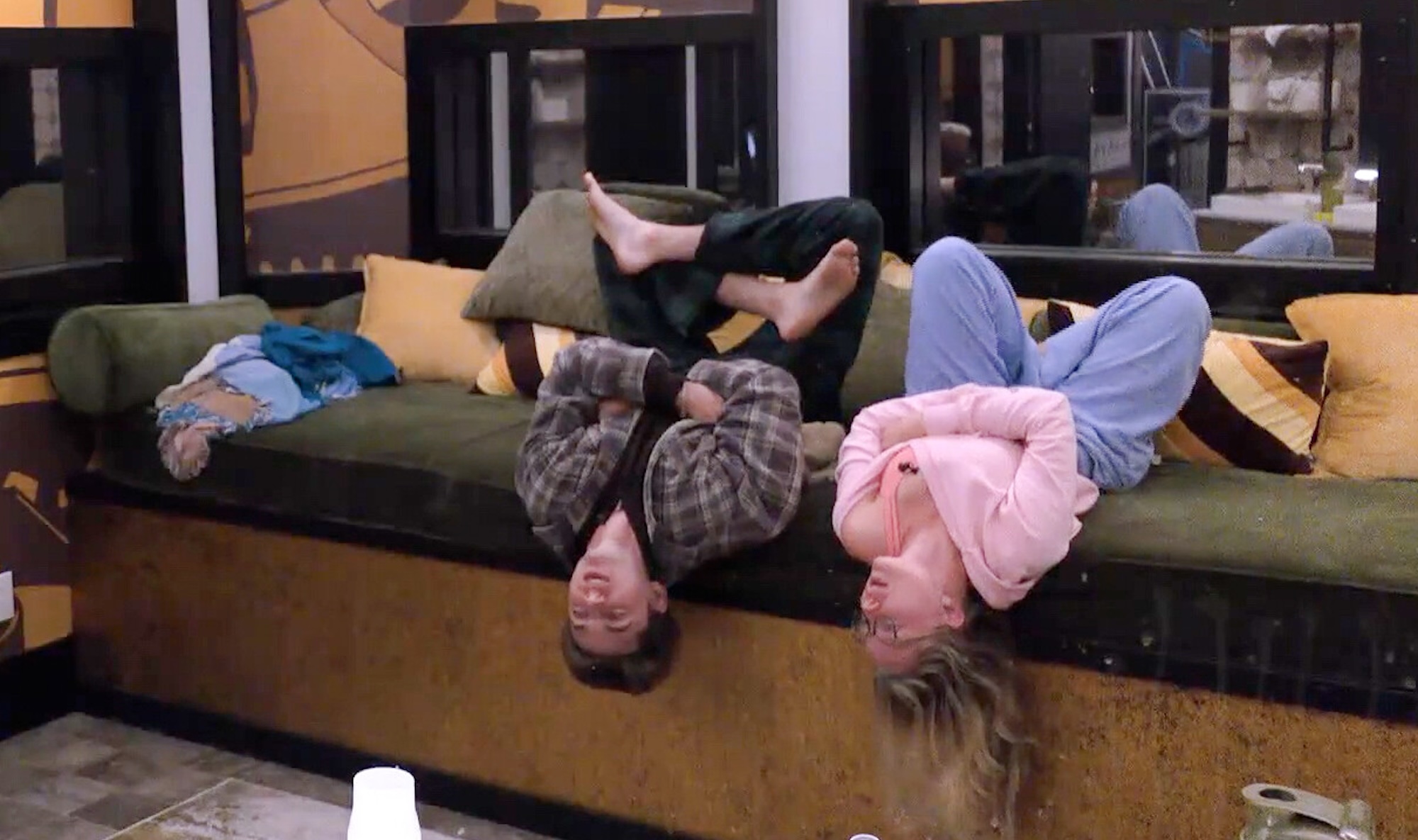 Drew and Melody talking upside down in the Big Brother bathroom 