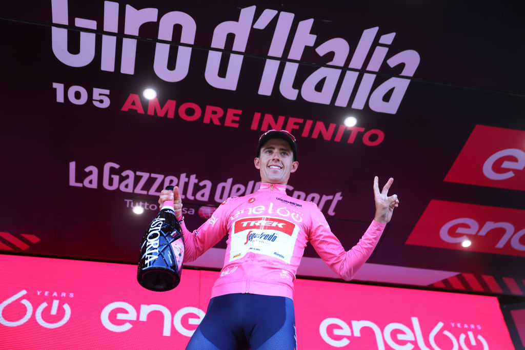 NAPOLI ITALY MAY 14 Juan Pedro Lpez of Spain and Team Trek Segafredo celebrates winning the pink leader jersey on the podium ceremony after the 105th Giro dItalia 2022 Stage 8 a 153km stage from Napoli to Napoli Giro WorldTour on May 14 2022 in Napoli Italy Photo by Michael SteeleGetty Images