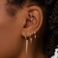Rook Piercing on an earlobe with maria tash earrings