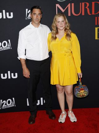 US actress Amy Schumer (R) and husband Chris Fischer arrive to the premiere of "Only Murders in the Building" season 2 at the Directors Guild of America in Los Angeles, California on June 27, 2022