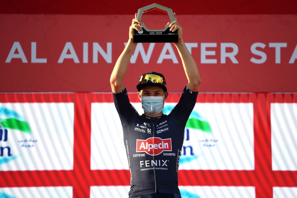 MADINAT ZAYED UNITED ARAB EMIRATES FEBRUARY 20 Jasper Philipsen of Belgium and Team AlpecinFenix celebrates at podium as Black Intermediate Sprint Jersey winner after the 4th UAE Tour 2022 Stage 1 a 184km stage from Madinat Zayed to Madinat Zayed UAETour WorldTour on February 20 2022 in Madinat Zayed United Arab Emirates Photo by Tim de WaeleGetty Images