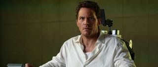 Chris Pratt as Chris Raven sitting in a chair in Mercy