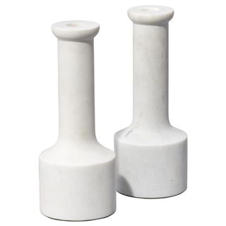 two white marble candlesticks in a pillar style