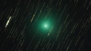 a green fuzzy dot in space