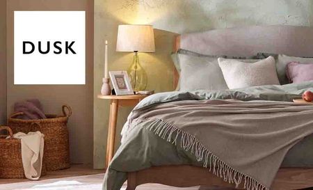 Dusk Logo placed over an image of a double bed
