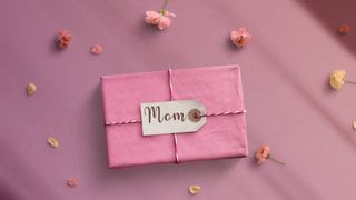 Mother's Day gift ideas — pink gift box surrounded by flowers