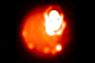 This high-resolution image of the volcanic regions Loki Patera and Amaterasu Patera on Jupiter's moon Io was captured from Earth using adaptive optics observations with the giant Keck and Gemini telescopes.