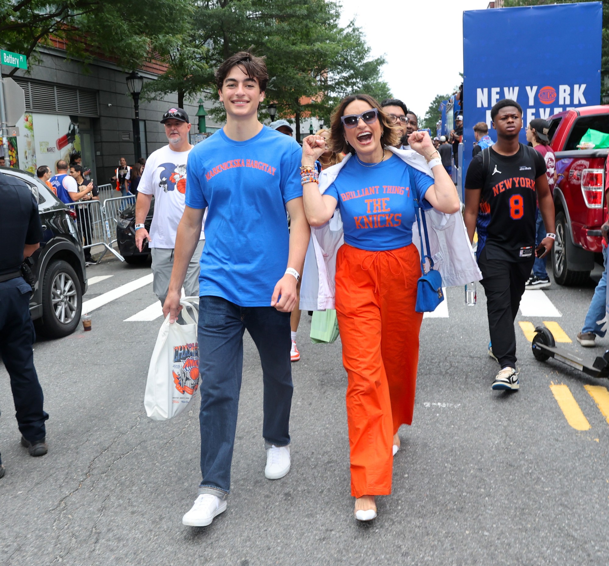 August Hermann and Mariska Hargitay are seen at the New York Knicks championship ticker-tape parade in NYC. He's wearing a shirt that says Marknicksa Hargitay.