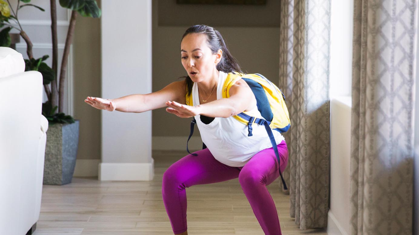 a woman wearing a backpack with weights