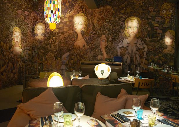 Dining area with intricately painted walls &amp; colourful lanterns