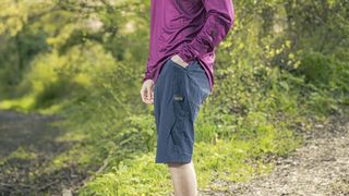 Man wearing Gore Fernflow shorts with grassy backdrop