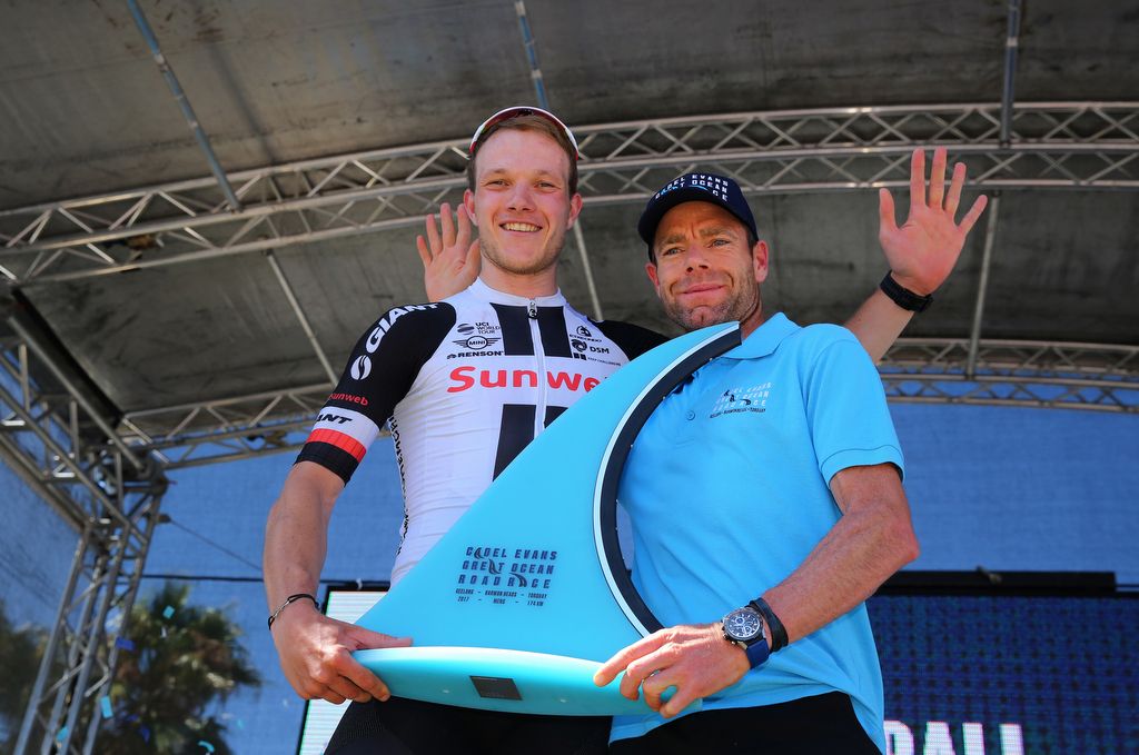 Nikias Arndt with his shark fin trophy and Cadel Evans on stage