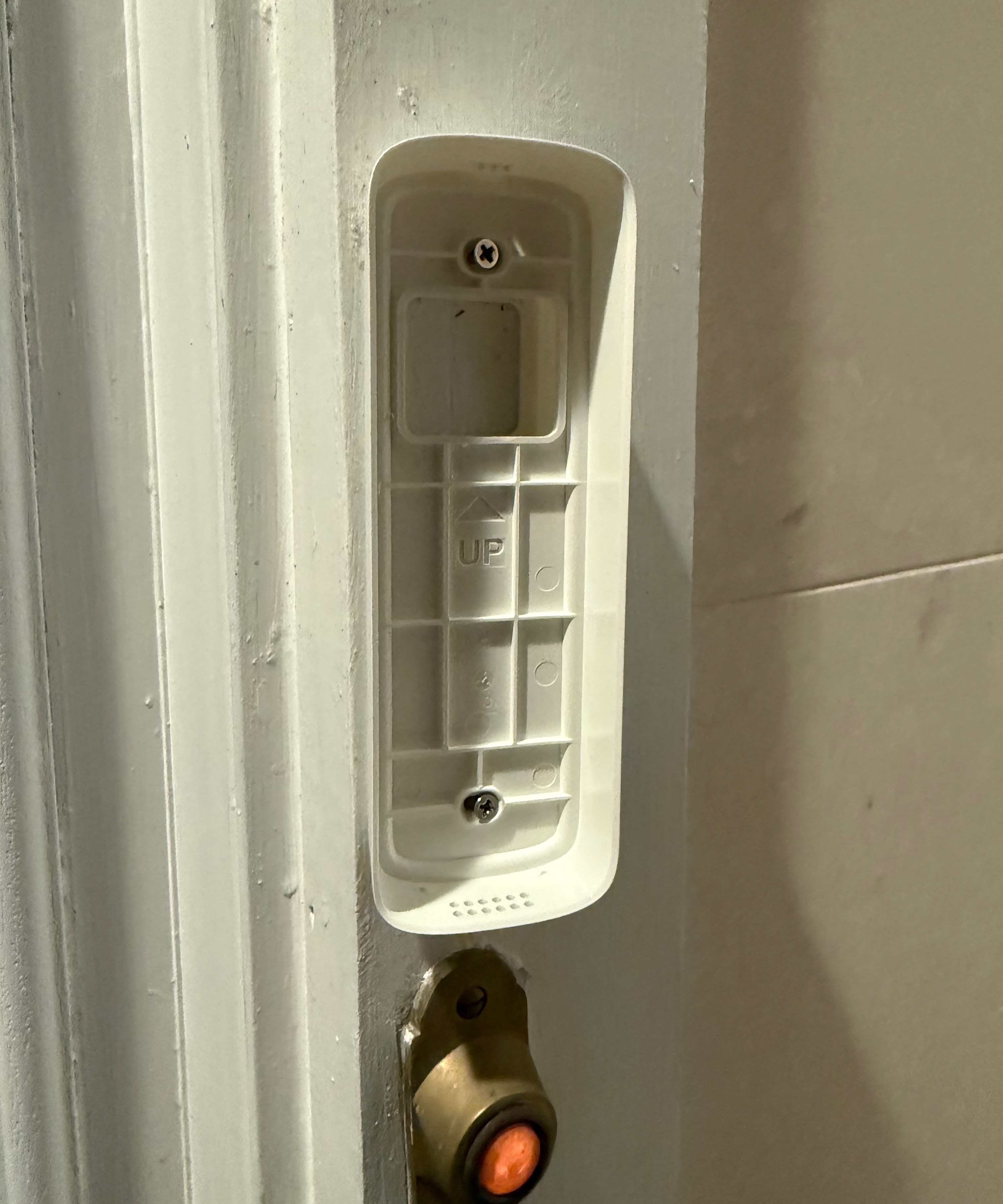 Baseplate of Lorex 2K WI-FI Video Doorbell is installed on doorframe.