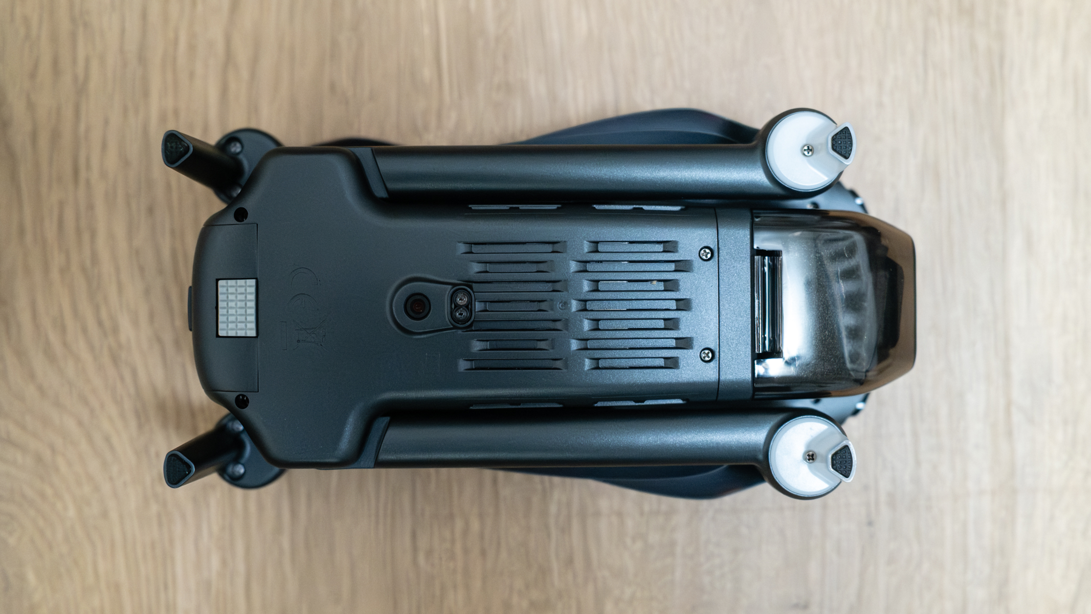 Bwine F7GIM bottom view folded on a wooden floor.