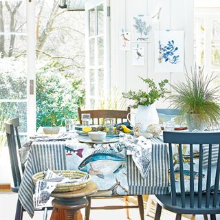 coastal dining room with blue and white accessories and open french door