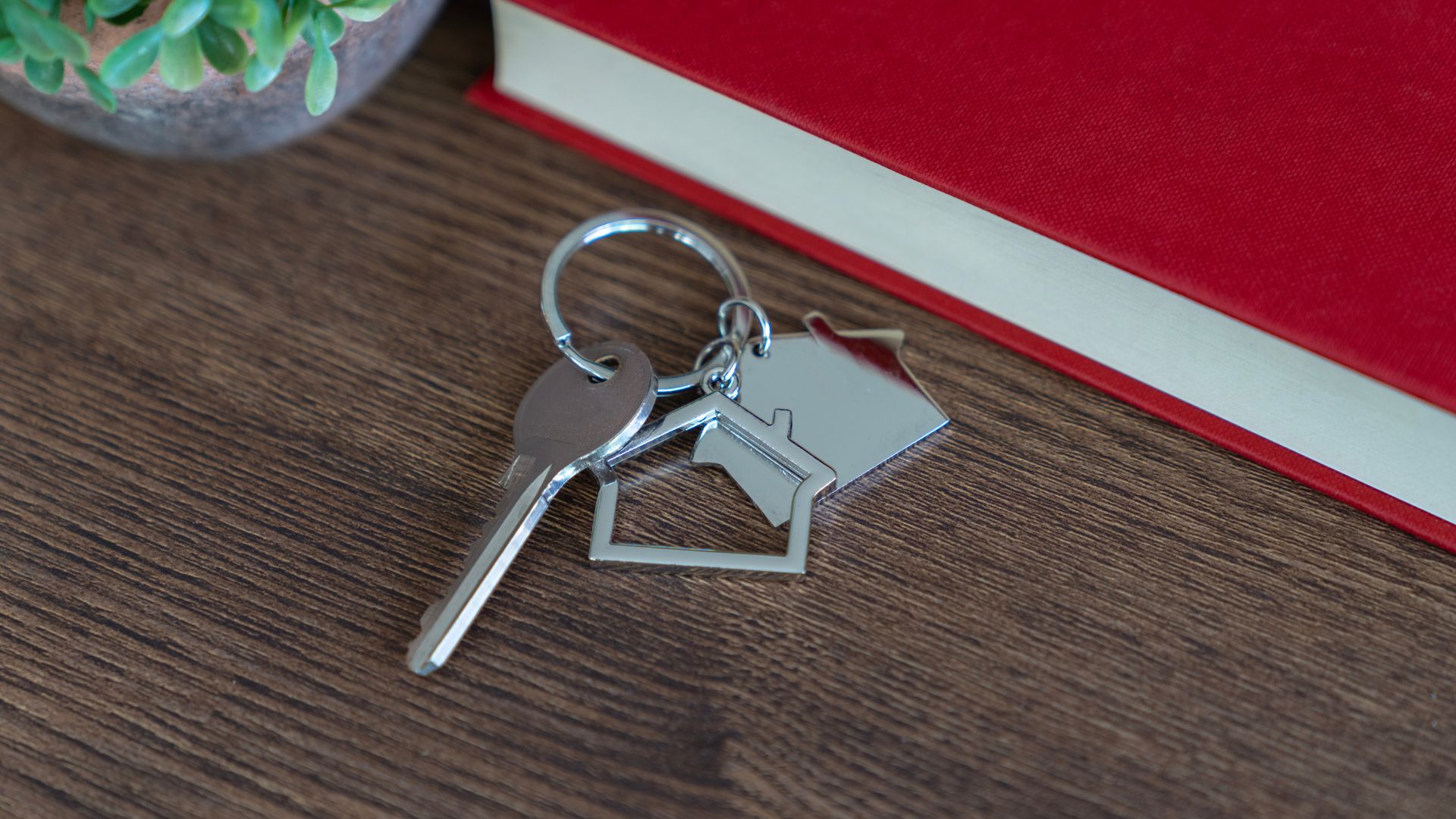 picture of house keys on table next to a book