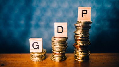 an image of pennies with the letters GDP on top of them