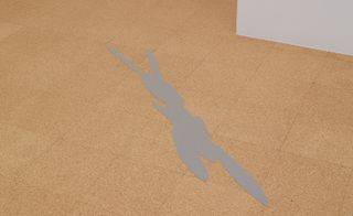 A rabbit-like shadow on a brown tiled concrete floor in a room with a peek of the white wall in the top right corner