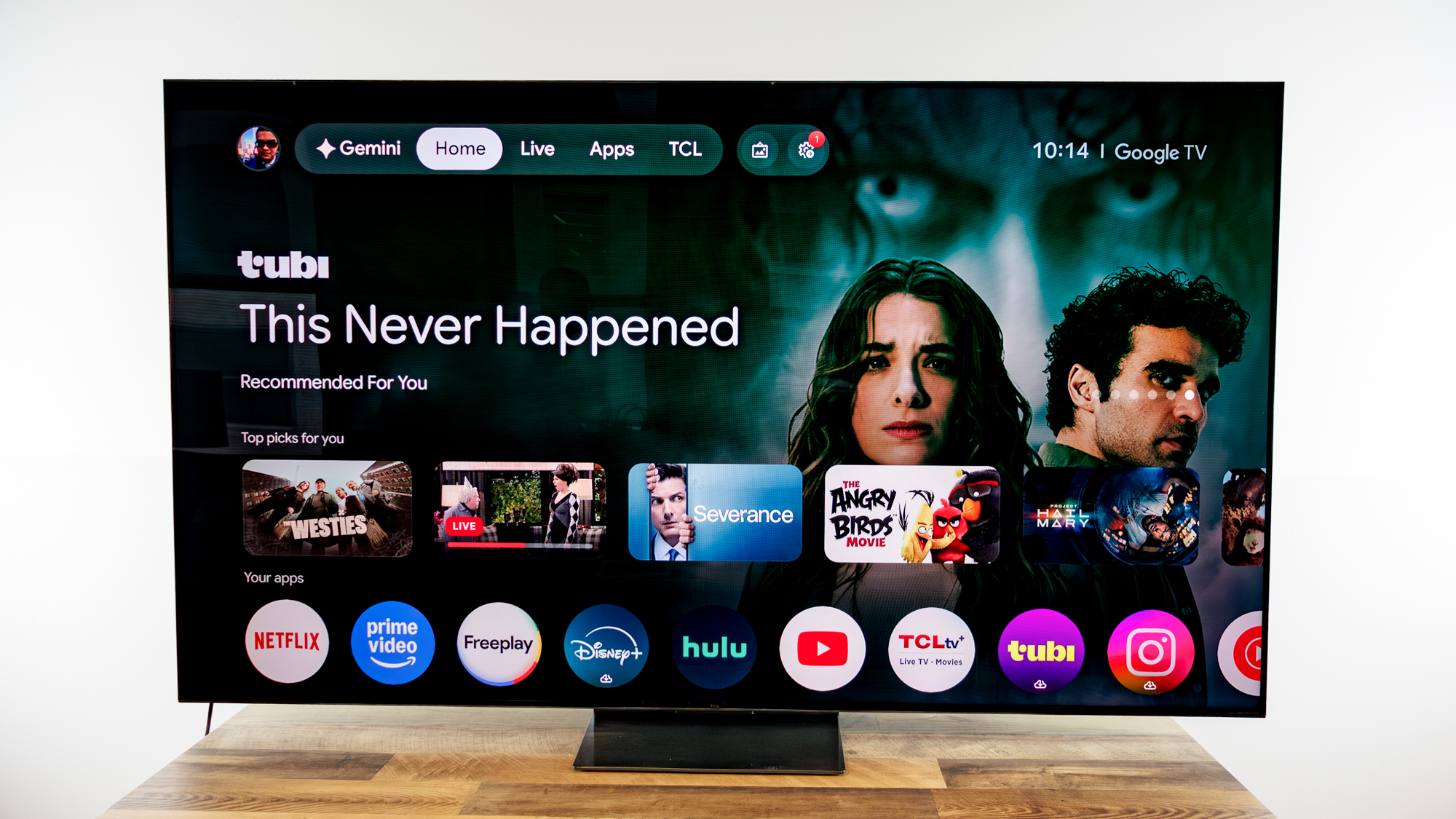 TCL QM7L 75-inch TV on a desk