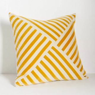 yellow and white striped patterend cushion