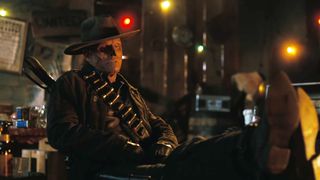 The Ghoul relaxing by a fire