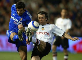 Valencia's Amedeo Carboni competes with Real Madrid's Luis Figo for the ball in March 2005.