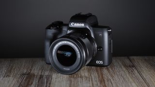A Canon EOS M50 Mark II in front of a black background, one of the best cheap cameras