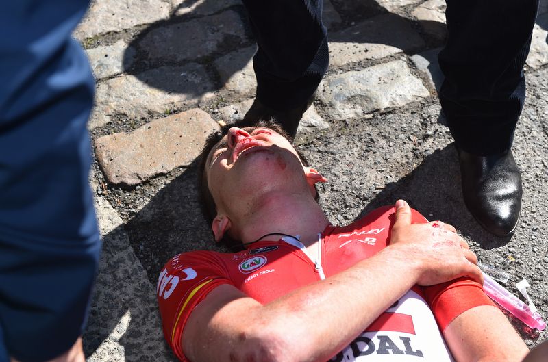 Lotto Soudal's Tiesj Benoot lays on the ground after a heavy crash