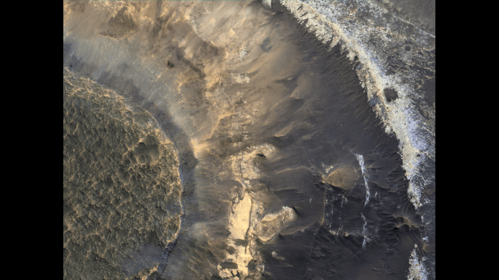 A photo of Mars landscape, with brown cracks and rock formations