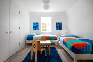A child's bedroom with natural light and ceiling light