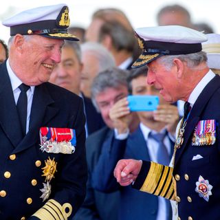 King Harald and King Charles laughing in military uniforms 