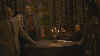 Several cast members stand singing around a piano in What We Do in the Shadows S6 E11 - 