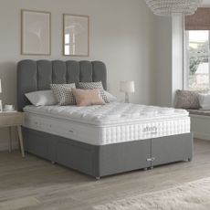 Grey bed with white mattress in neutral bedroom