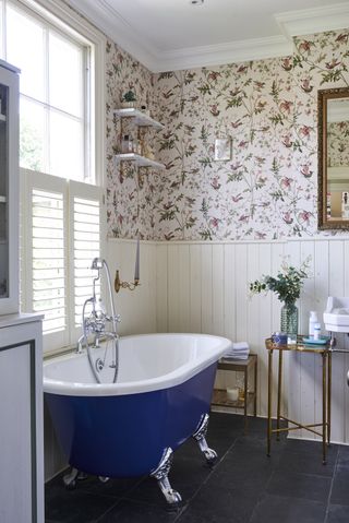 Bathroom with blue freestanding bath in bathroom with panelled walls