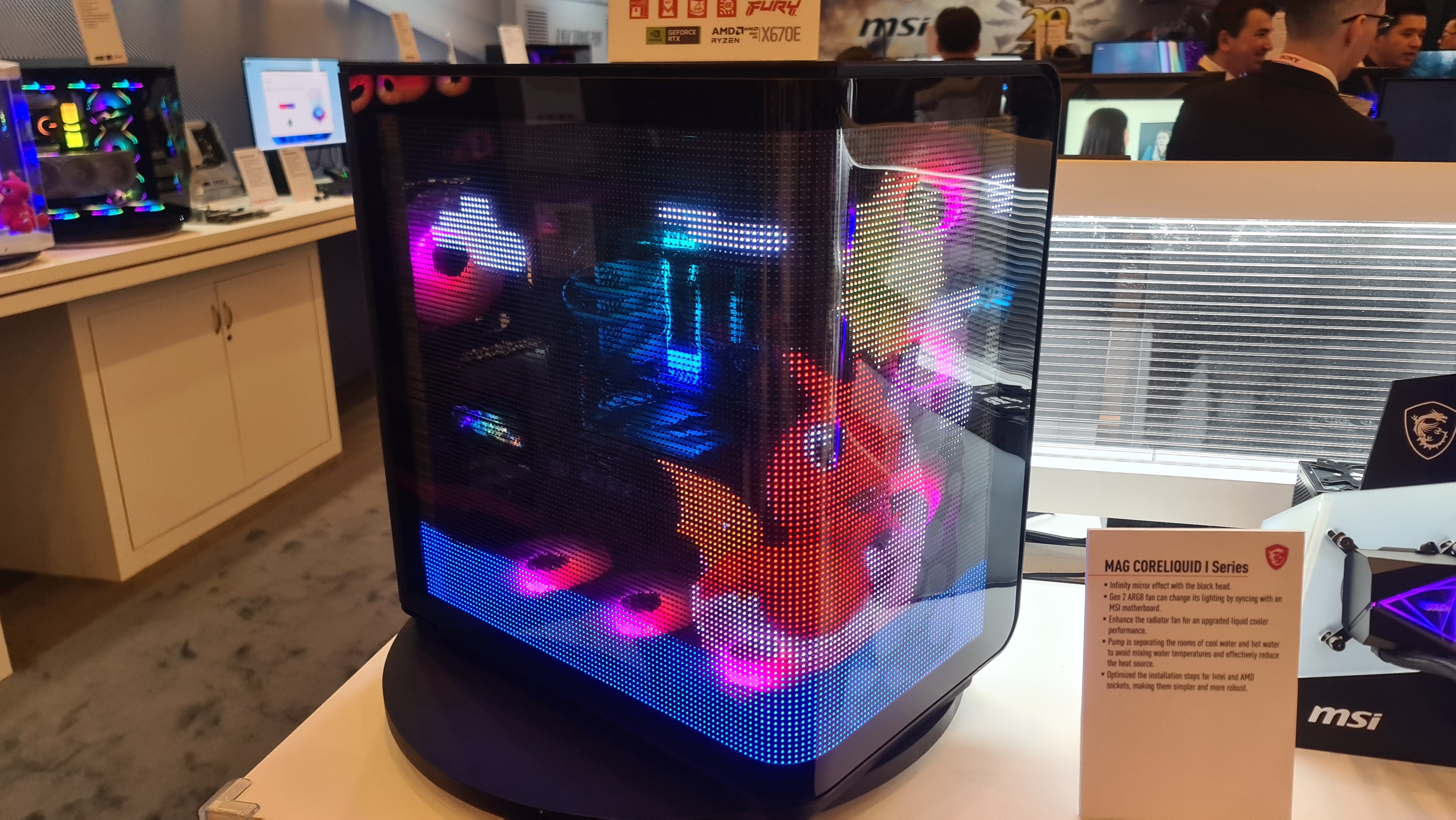 The MSI Maestro 700L PZ at CES 2024, with a transparent LED crystal film display in the case displaying a dragon
