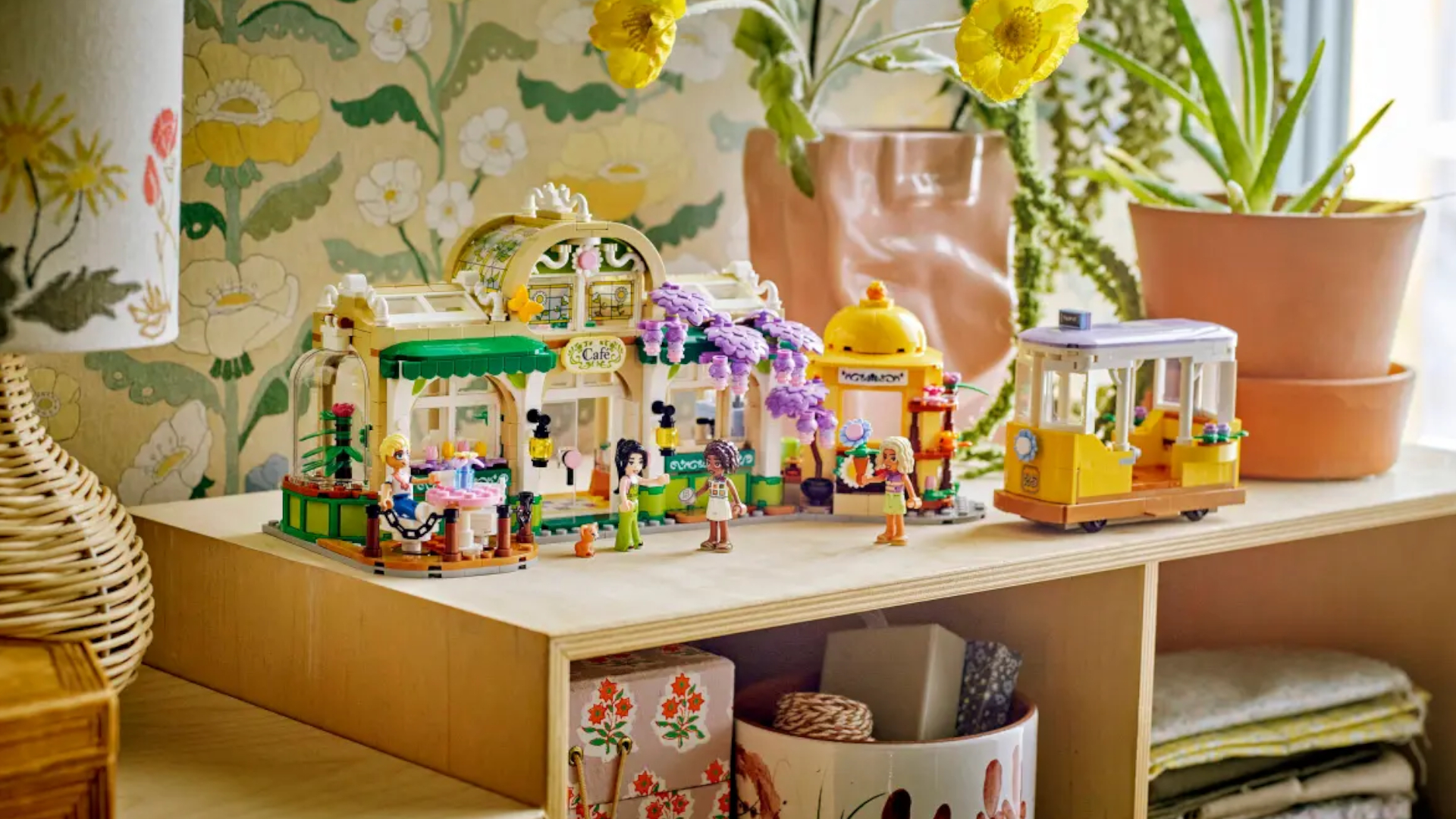 Lego Plant Cafe & Flower Shop on a sideboard against plant wallpaper
