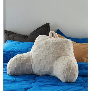 cream shearling chair-like pillow in a checker design