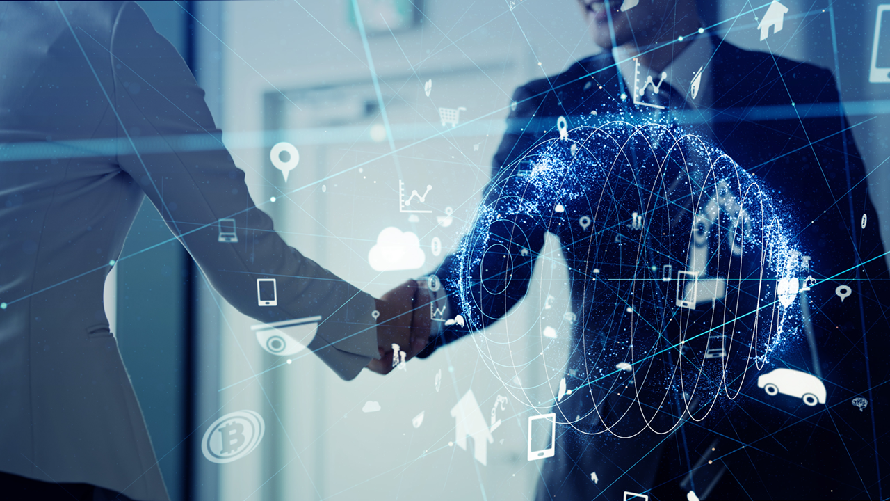 Two business people shaking hands with digital globe object. 