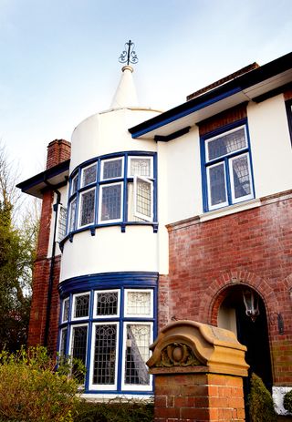 An Arts and Crafts influence is seen on this home, with leaded lights