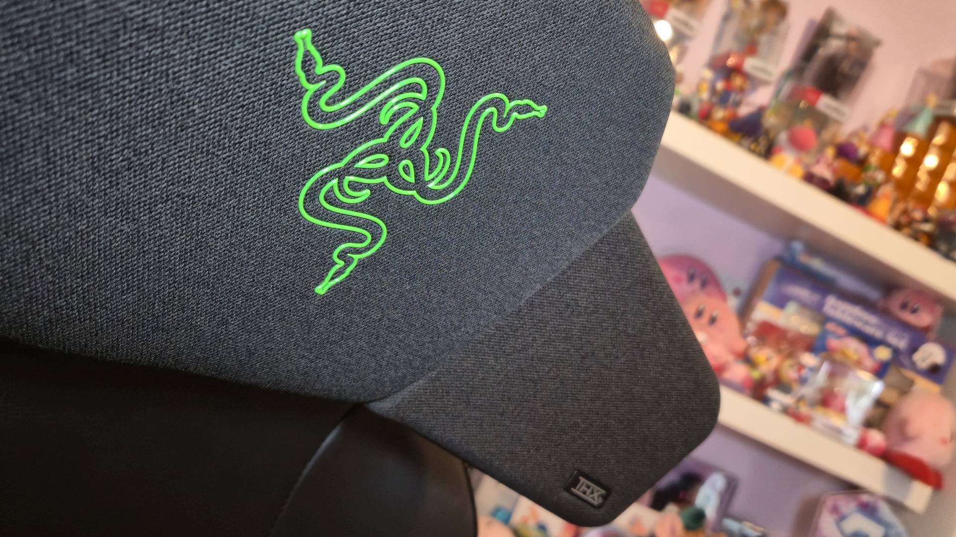 Photo by Rosalie Newcombe of the Razer Clio wireless speaker cushion sitting on a gaming chair.