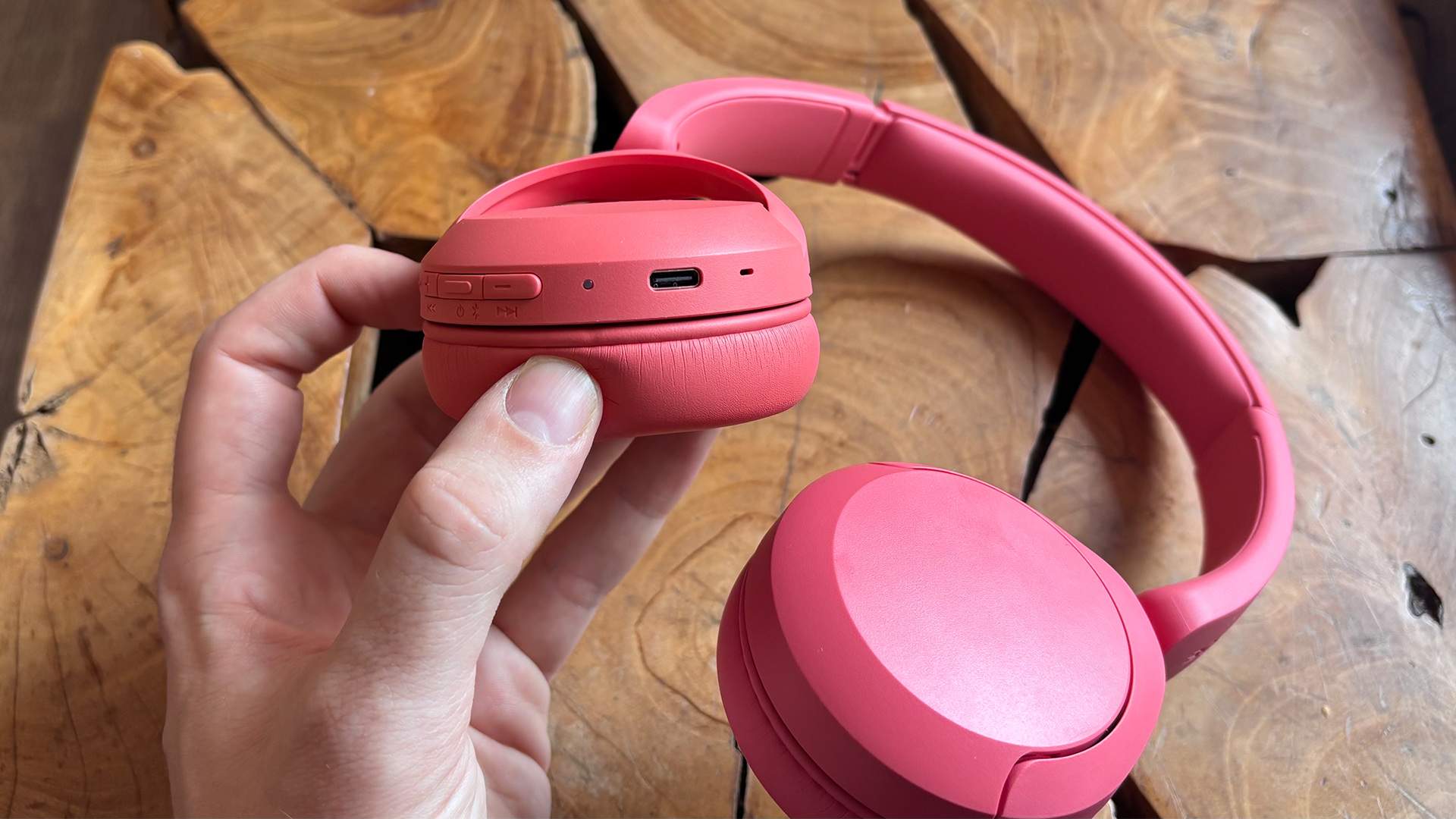 Sony WH-CH530 wireless headphones with one earcup held in hand showing connection and buttons