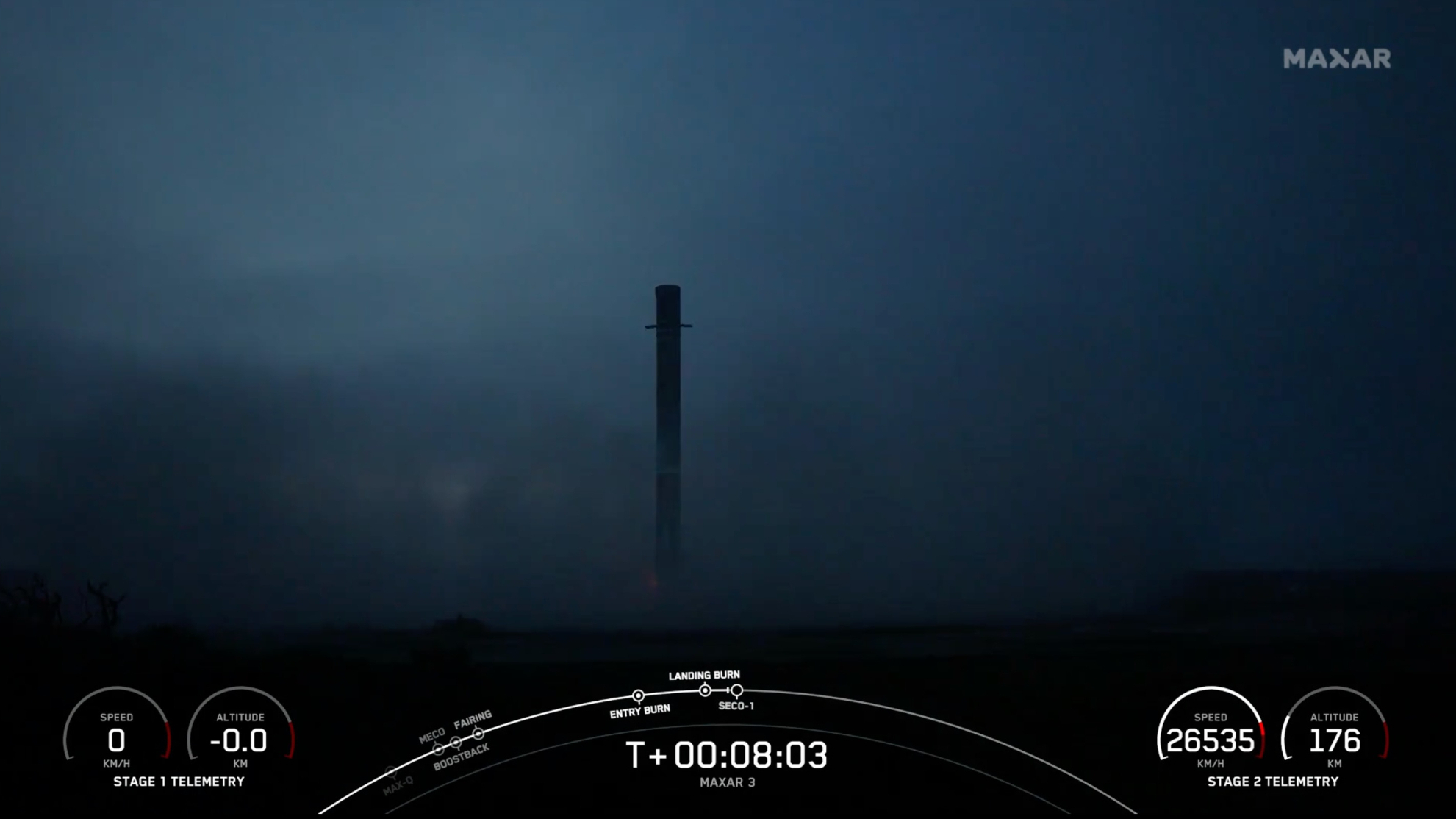 A black and white SpaceX Falcon 9 -rocket first phase sits on a landing pillow.