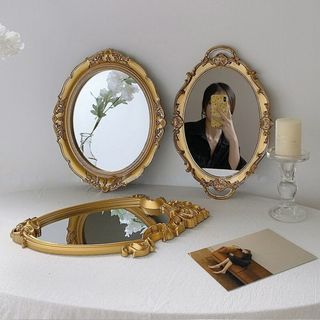 Vintage-style baroque mirrors with person taking selfie