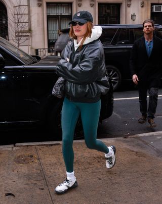 Hailey Bieber wears green leggings.