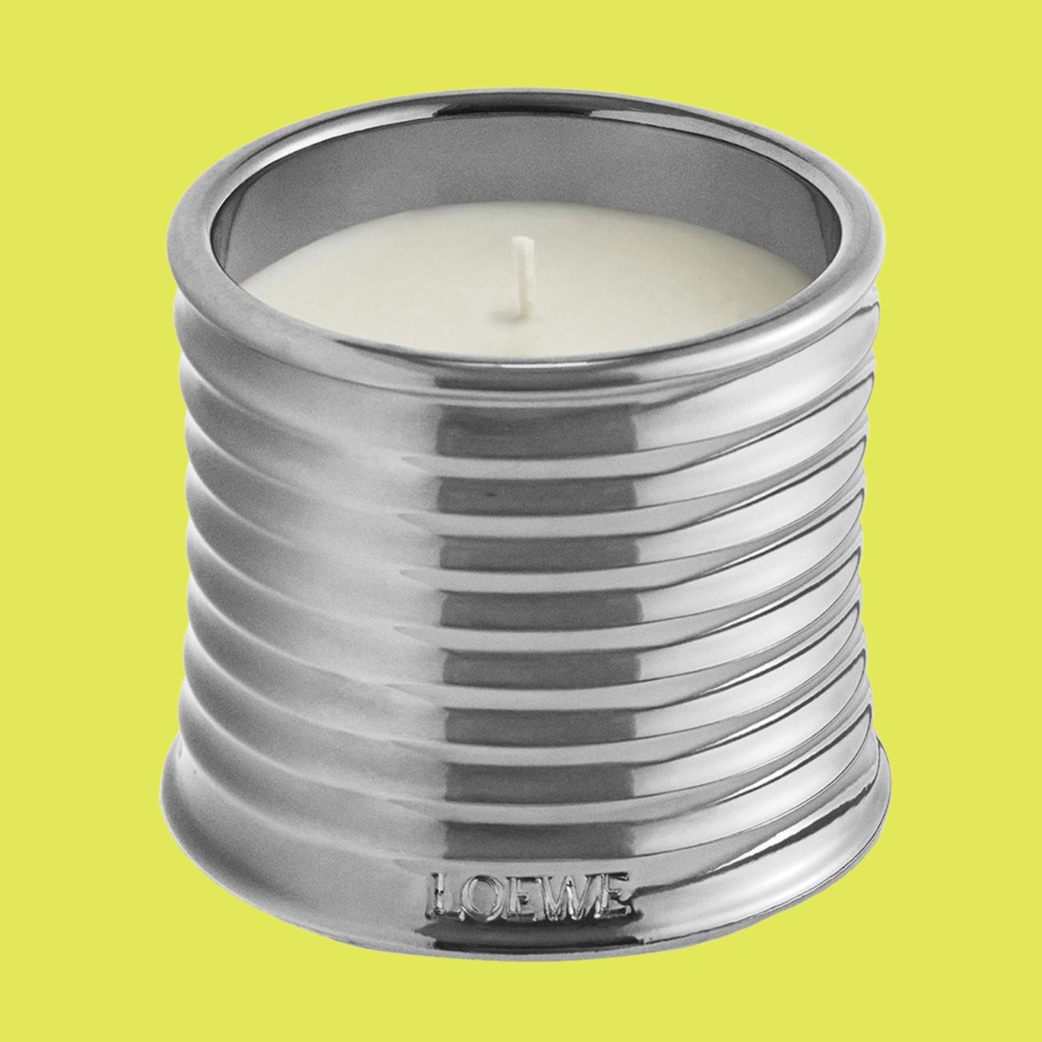 A silver ribbed candle scented with black sesame